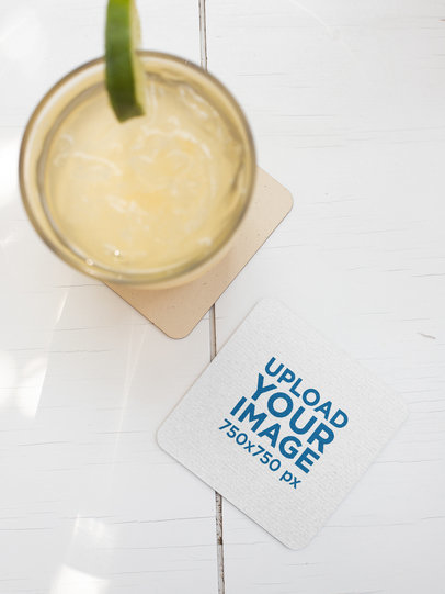 Square Coaster Mockup Featuring a Glass of Lemonade on a White Table