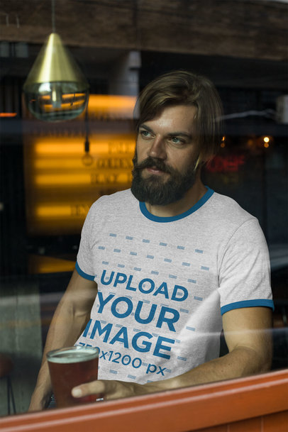 Ringer Tee Mockup Featuring a Bearded Man Holding a Glass Behind a Window 27929