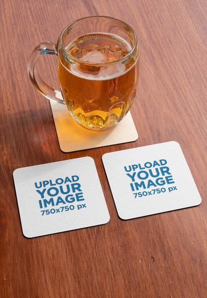 Mockup of Two Squared Coasters by a Jar of Beer