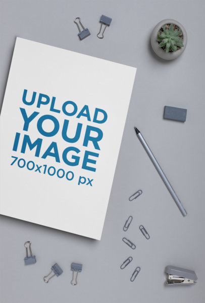 A4 Letterhead Mockup on a Gray Surface Next to Some Paper Clips 27220