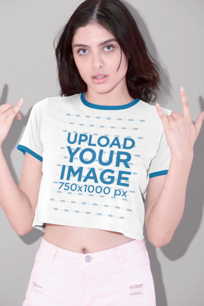 Ringer T-Shirt Mockup of a Woman Doing the Rock and Roll Sign 