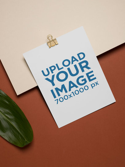 Mockup of an A4 Letterhead Attached to a Binder Clip on a Bicolor Surface