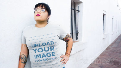 T-Shirt Video of a Tattooed Woman Posing Outside a White Building 12645