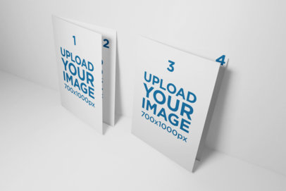 Mockup of Two Folded A5 Brochures Standing Next to Each Other Against a Flat Surface 32-el