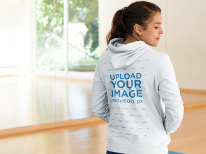 Back Shot of a Woman in a Hoodie at a Yoga Class