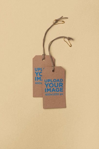 Minimal Mockup Featuring Two Brand Tags Lying on a Solid Color Surface 27655