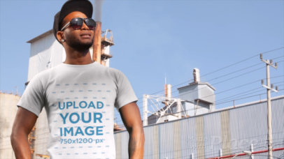 T-Shirt Video of a Trendy Man Standing Outside a Factory