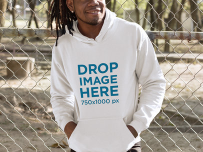 Smiling Man With Locs Leaning on a Fence Hoodie Mockup