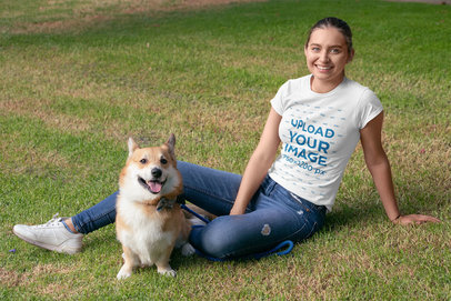 T-Shirt Mockup Featuring a Woman Lying on the Grass Next to Her Puppy