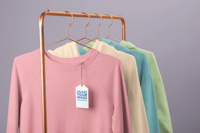 Clothing Tag Mockup Featuring a Rack of Crewneck Sweatshirts