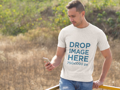 Man Using an iPhone Outdoors Camping T-Shirt Mockup
