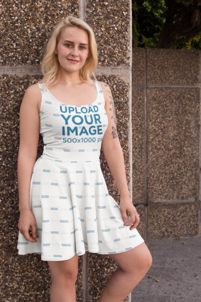 Skater Dress Mockup Featuring a Tattooed Woman Leaning Against a Wall