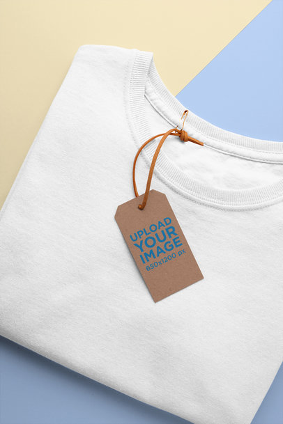 Mockup of a Clothing Tag Attached to a Folded T-Shirt