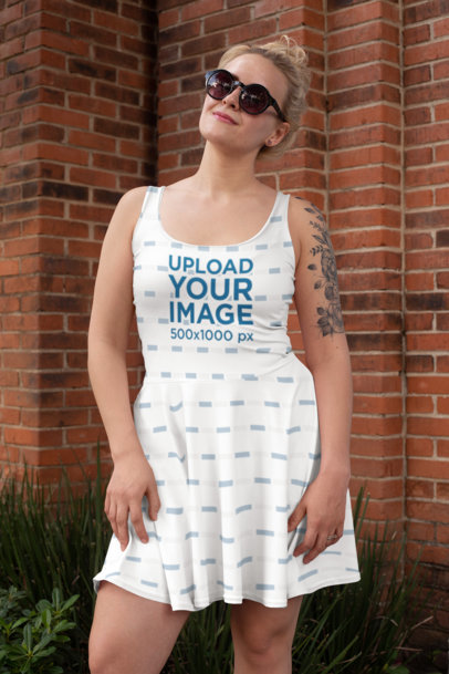 Skater Dress Mockup of a Tattooed Woman with Sunglasses with a Brick Wall in the Background 