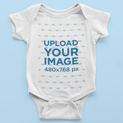 Mockup of a Little Baby's Onesie Over a Flat Surface