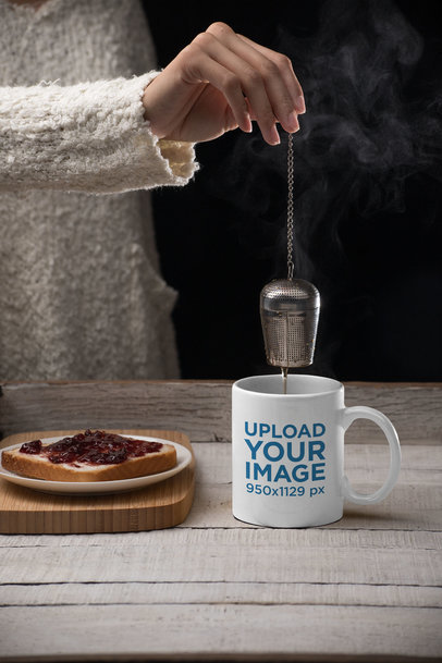 Mockup of an 11 oz Mug with a Tea Infuser on a Wooden Table 
