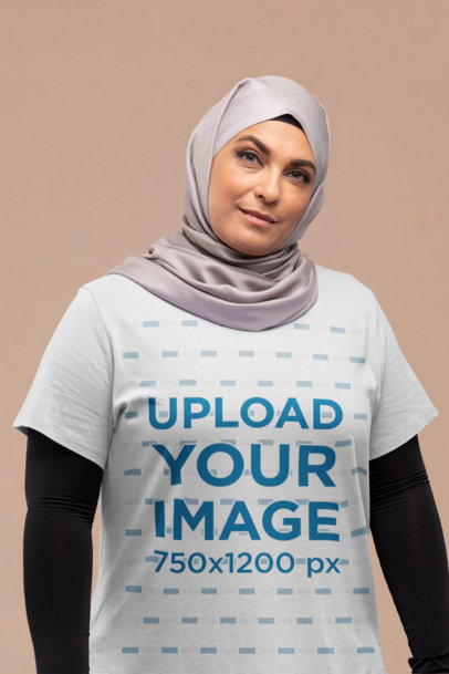 T-Shirt Mockup of a Woman with a Hijab at a Studio 
