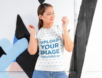 Shirt Mockup of a Woman Posing Against a Street Art Mural 28202
