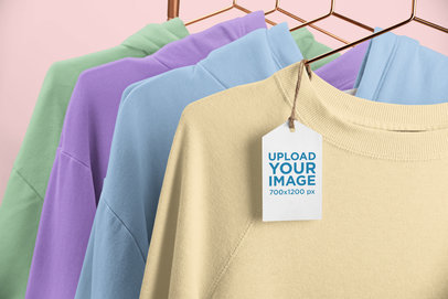 Brand Tag Mockup Featuring a Rack of Crewneck Sweatshirts 27633