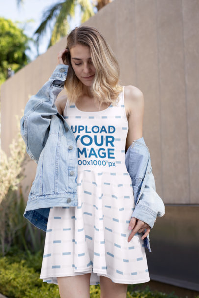 Mockup of a Woman Wearing a Sublimated Skater Dress While Looking Down