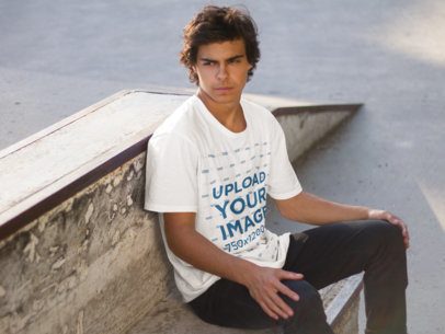 Young Man Sitting on a Concrete Bench T-Shirt Mockup