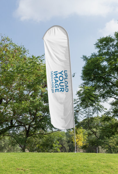 Mockup of a Flag Banner Standing on a Lawn by Some Trees 