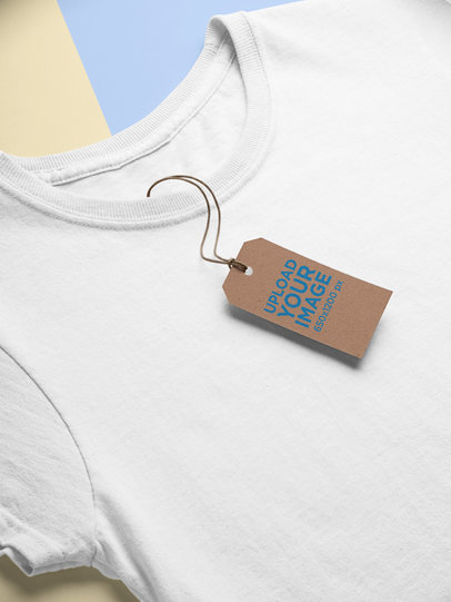 Mockup of a Cardboard Brand Tag Lying on a T-Shirt