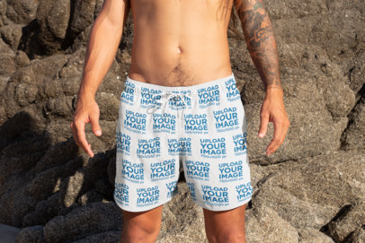 Mockup Featuring a Tattooed Man Wearing Swim Trunks 