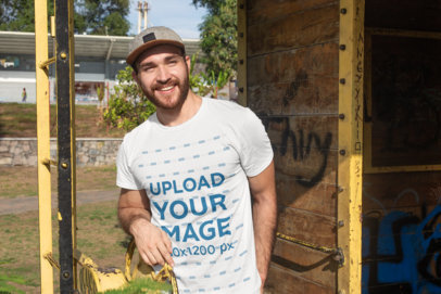 T-Shirt Mockup Featuring a Smiling Man with a Beard at the Park