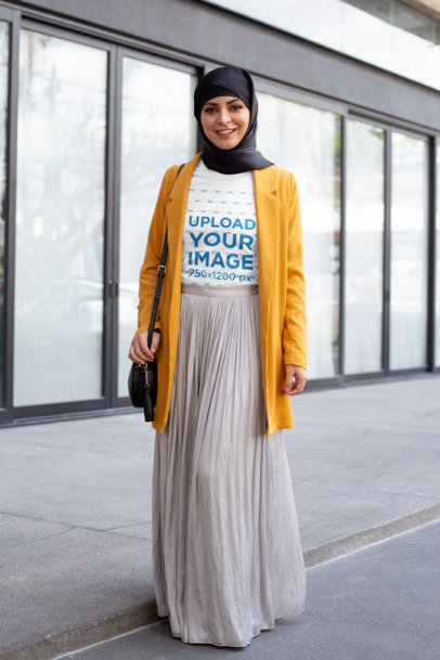 T-Shirt Mockup of a Woman With a Hijab Walking in the City