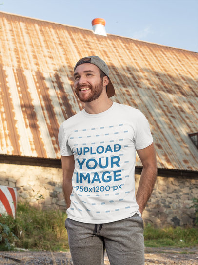 T-Shirt Mockup of a Man Posing in Front of an Old Structure