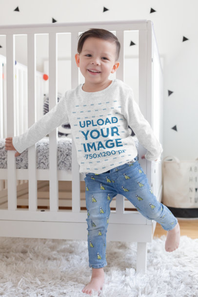 Long Sleeve Shirt Mockup of a Kid Standing Next to a Baby Cradle 