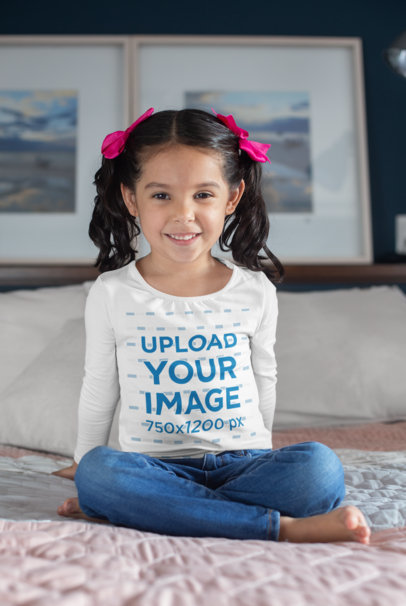 Long Sleeve Shirt Mockup Featuring a Little Kid Sitting over a Bed