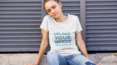 T-Shirt Video Featuring a Woman Sitting Against a Metal Roll-Up Door 12113