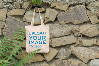 Mockup of a Bag Hanging on a Stone Wall by Some Plants 110-el