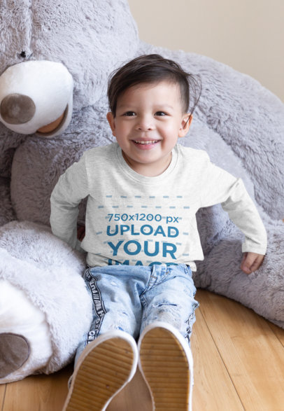 Heathered Long Sleeve Tee Mockup of a Kid Sitting by a Teddy Bear