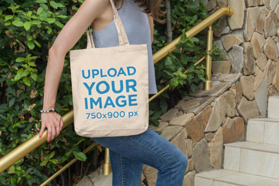 Tote Bag Mockup of a Woman Leaning Against a Handrail by Some Plants