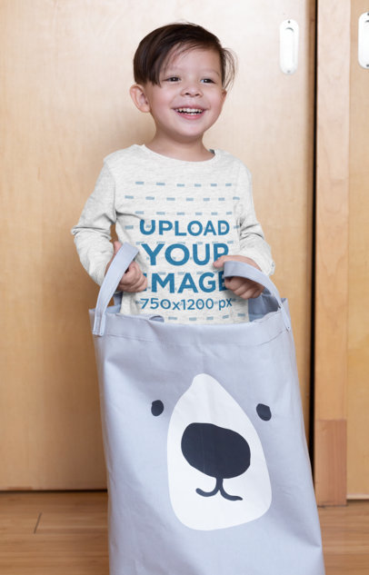 Heather Long Sleeve T-Shirt Mockup Featuring a Kid Playing with a Laundry Bag