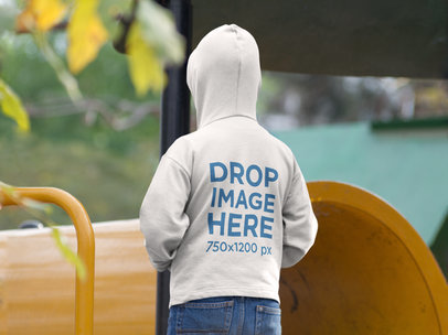 Mockup of the Back of a Boy Wearing a Hoodie at the Park
