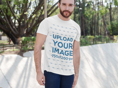 T-Shirt Mockup Featuring a Bearded Man Posing at an Urban Park 