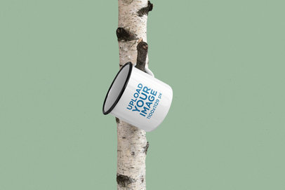 Mockup of a 12 oz Enamel Mug Hanging on a Tree
