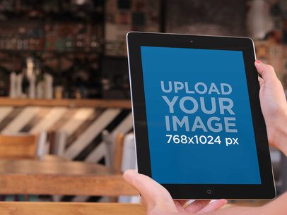 iPad Mockup Featuring a Woman in a Restaurant