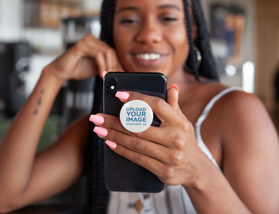 Phone Grip Mockup Featuring a Smiling Woman Looking at Her iPhone 28163