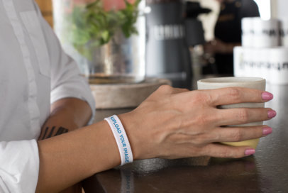Wristband Mockup of a Woman at a Cafe
