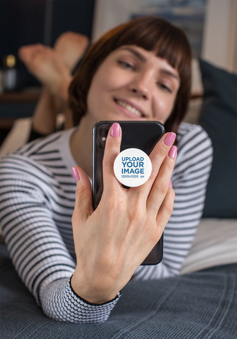 Phone Grip Mockup Featuring a Short-Haired Woman Checking Her Phone in Her Bedroom 