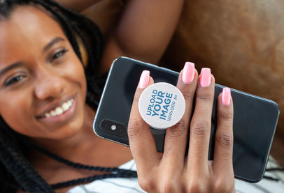 Phone Grip Mockup Featuring a Woman with Locks Lying on a Couch 28168