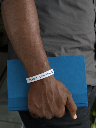 Silicone Wristband Mockup of a Man Holding a Book 28233