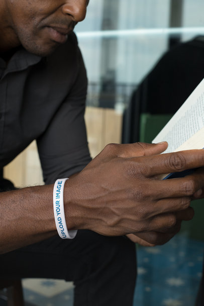 Silicone Wristband Mockup of a Man Reading a Book 