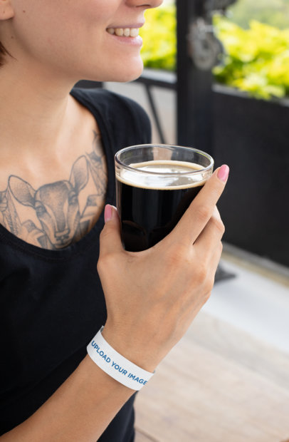 Paper Wristband Mockup Featuring a Woman Holding a Pint of Stout 