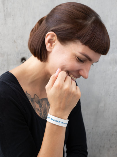 Mockup of a Tattooed Woman Wearing a Paper Wristband 